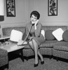 Young woman sitting on sofa and talking on the phone Poster Print - Item # VARSAL255418049 Young woman sitting on sofa and talking on the phone Poster Print - Item # VARSAL255418049