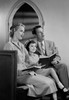 Girl with parents in church Poster Print - Item # VARSAL255418614