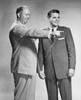 Two businessmen standing together  one pointing Poster Print - Item # VARSAL25547989