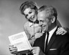 Senior couple reading a document and smiling Poster Print - Item # VARSAL25548870