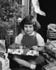 Close-up of a girl opening a Christmas present Poster Print - Item # VARSAL25520244