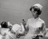 Female nurse holding a pill bottle and a patient on the bed behind her Poster Print - Item # VARSAL25526363