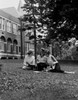 Three student girls sitting on lawn and learning Poster Print - Item # VARSAL255419325