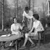 Young women and young man sitting in backyard and drinking water Poster Print - Item # VARSAL255420757