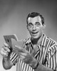 Close-up of a young man holding a bankbook and an envelope Poster Print - Item # VARSAL25534241