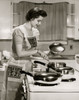 Side profile of a young woman cooking food in the kitchen Poster Print - Item # VARSAL2553334 Side profile of a young woman cooking food in the kitchen Poster Print - Item # VARSAL2553334