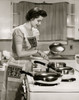 Side profile of a young woman cooking food in the kitchen Poster Print - Item # VARSAL2553334