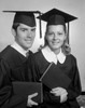 Female and male students wearing graduation gown holding diploma Poster Print - Item # VARSAL255416291