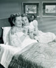 Mother and daughter sitting in bed Poster Print - Item # VARSAL255417285