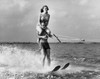 Young man waterskiing with young woman sitting on his shoulder Poster Print - Item # VARSAL255339A