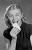 Greedy young woman eating biscuit Poster Print - Item # VARSAL255418887