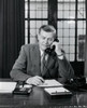 Mature businessman talking on telephone in office Poster Print - Item # VARSAL25548253