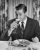 Mid adult man sitting at table drinking beer Poster Print - Item # VARSAL2554229B