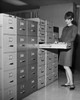 Businesswoman searching for files in filing cabinet Poster Print - Item # VARSAL25548417