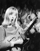 Portrait of a young woman playing an electric guitar and singing Poster Print - Item # VARSAL25544445