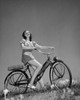 Low angle view of a teenage girl sitting on a bicycle Poster Print - Item # VARSAL25517499