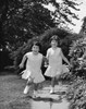 Portrait of two girls holding hands and running Poster Print - Item # VARSAL25516311