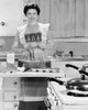 Young woman using egg beater in kitchen Poster Print - Item # VARSAL25518514B