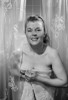 Portrait of young woman in shower  wrapped in towel Poster Print - Item # VARSAL255416920