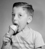 Portrait of boy eating icecream   studio shot Poster Print - Item # VARSAL2555483A