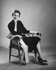 Portrait of a mid adult woman sitting in an armchair Poster Print - Item # VARSAL25519586