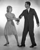Woman pulling man  studio shot Poster Print - Item # VARSAL255417386