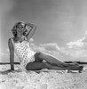 Young woman wearing swimsuit sitting on beach Poster Print - Item # VARSAL255418011