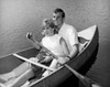 Young couple rowing rowboat and smiling Poster Print - Item # VARSAL2552675