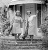 Mature woman and young woman standing on steps of house Poster Print - Item # VARSAL255418560