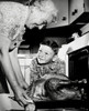 Grandmother taking a turkey from the oven with her grandson watching Poster Print - Item # VARSAL2553138