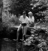 Young couple sitting by pond Poster Print - Item # VARSAL255416494