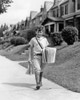 1930s Boy Newsboy Looking At Camera Delivering Newspapers Walking Along Suburban Street Of Row Houses Print By Vintage - Item # PPI177436LARGE