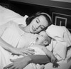 Young woman lying in bed with her baby Poster Print - Item # VARSAL255417387