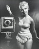 Young woman standing with a camera Poster Print - Item # VARSAL255967