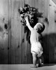 Rear view of a baby boy reaching for a cuckoo clock Poster Print - Item # VARSAL25526757