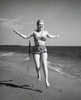 Portrait of a young woman running on the beach Poster Print - Item # VARSAL25511214