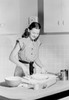 Young woman preparing cake in domestic kitchen Poster Print - Item # VARSAL255422349B