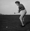 Mid adult woman swinging a golf club on a golf course Poster Print - Item # VARSAL2558894