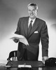 Businessman standing at a desk and holding documents in an office Poster Print - Item # VARSAL25548306A