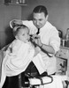 Portrait of a boy getting a haircut from a barber Poster Print - Item # VARSAL2557858