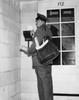 Side profile of a postman delivering mail Poster Print - Item # VARSAL25511569