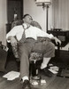 Young man resting on an armchair  drunk Poster Print