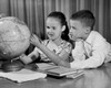 Close-up of a boy and his sister looking at a globe Poster Print - Item # VARSAL25516396