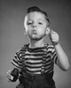 Portrait of boy blowing bubbles with bubble wand Poster Print - Item # VARSAL25512774