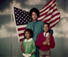 Portrait of a mid adult woman standing with her daughter and son in front of an American flag Poster Print - Item # VARSAL3811361918