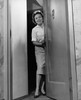 Mid adult woman opening a door Poster Print - Item # VARSAL25527196