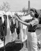 Young woman hanging clothes on a clothesline Poster Print - Item # VARSAL25529027