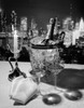 1970s Champagne Bottle In Ice Bucket With Glasses Candle & Napkins On Table & New York City Night Skyline In Background - Item # PPI186882LARGE