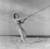 Young happy woman pulling rope at beach Poster Print - Item # VARSAL255424609