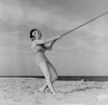 Young happy woman pulling rope at beach Poster Print - Item # VARSAL255424609